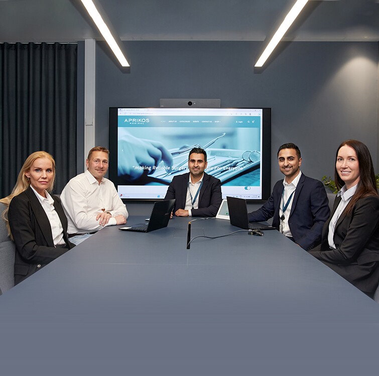 Five people sitting around a table.